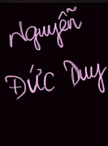 the name duc duy is written in chalk on a black board