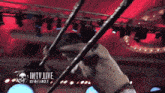 a man in a wrestling ring with the words iwtv live on the bottom right