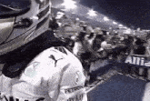 a man wearing a helmet and a shirt that says petronas