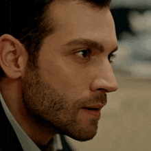a man with a beard is looking at something
