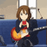 a girl is sitting on a couch holding a guitar and eating toast
