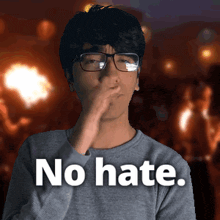 a man with glasses covering his nose with his hand and the words " no hate " written below him