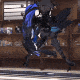 a woman in a black and blue costume is dancing in a room