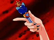 a pixel art of a hand holding a blue wand