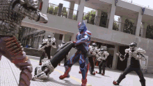 a group of skeletons are fighting each other on the sidewalk