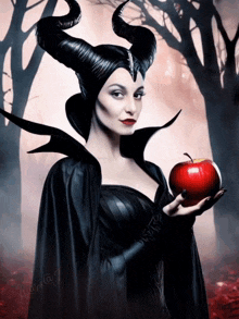 a woman with horns is holding an apple in her hand