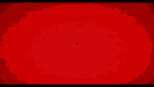 a red light is shining through a circle of wires on a red background