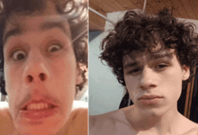 a young man with curly hair making a funny face