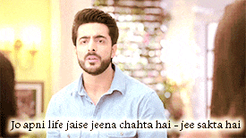 a man with a beard stands in front of a sign that says jo apni life jaise jeena chahta hai