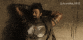 a man with a beard is leaning against a wall with the hashtag avantika_0902