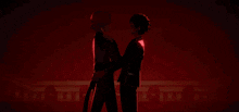 two anime characters standing next to each other with a red background