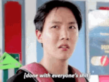 a man with a backpack is saying done with everyone 's shit .