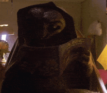 an alien is reading an abc book