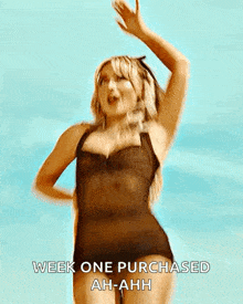 a woman in a black swimsuit is dancing and says week one purchased ah-ahh