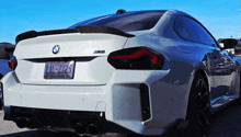 a white bmw with a california license plate that says lnl-2725