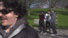 a blurry photo of a man wearing sunglasses and a black jacket