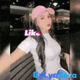a woman wearing a pink hat and a white shirt with the words like by lysera below her