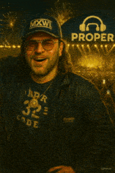 a man wearing a mxwi hat and a proper shirt is smiling