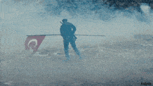 a man holding a flag with a c and a star on it
