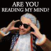 a man wearing sunglasses has his hands on his head and the words are you reading my mind above him