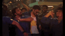 a man is dancing in front of a crowd of people .