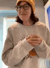 a woman wearing a beanie and a sweatshirt that says ' quirk ' on the front