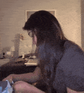 a woman is sitting at a desk with a laptop