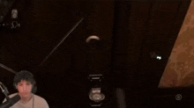 a man wearing headphones is playing a video game in a dark room