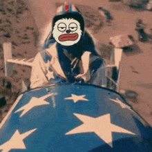 a cartoon character is riding on the back of a blue vehicle with stars on it .