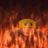 a person wearing a yellow hat with googly eyes is surrounded by fire .