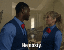 a man and a woman are standing next to each other and the man is saying he nasty