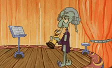 squidward from spongebob squarepants is holding a trumpet in his hand