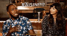 a man and a woman are sitting on a couch with the man saying " raisin "