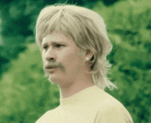 a man with a mullet and a mustache is wearing earrings