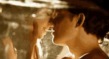 a close up of a man and woman kissing with the letter x visible