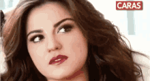 a close up of a woman 's face with the word caras on the bottom