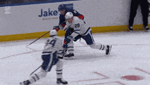 a hockey game is being played in front of a jake casino hotel sign