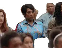 a woman in a blue shirt is surrounded by other people
