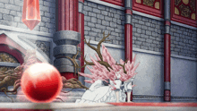 a red ball is being thrown in a room with a brick wall