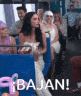 a woman in a wedding dress is sitting on a bus with other people and says bajan !