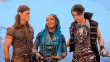 a group of people standing next to each other in a scene from the movie descendants .