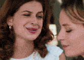a woman with braces on her teeth is smiling next to another woman with braces on her teeth