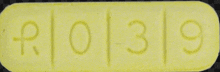 a close up of a yellow pill that says r01319 on it