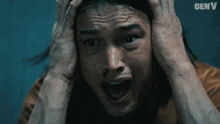 a man with his hands on his head and the word genv on the bottom right