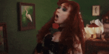 a woman with red hair is standing in a bedroom with the words well back at my house i got a california king on the bottom