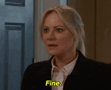 a woman in a suit is saying fine in yellow