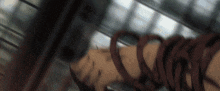 a blurred image of a person with a red ribbon around their waist