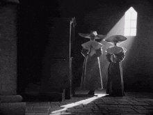 a black and white photo of two nuns wearing white robes and hats