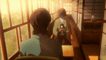a man and a woman are standing in a hallway looking out the window .