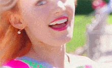 a close up of a woman 's face with her mouth open and earrings .